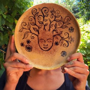 An image of a tree spirit on a ceramic plate